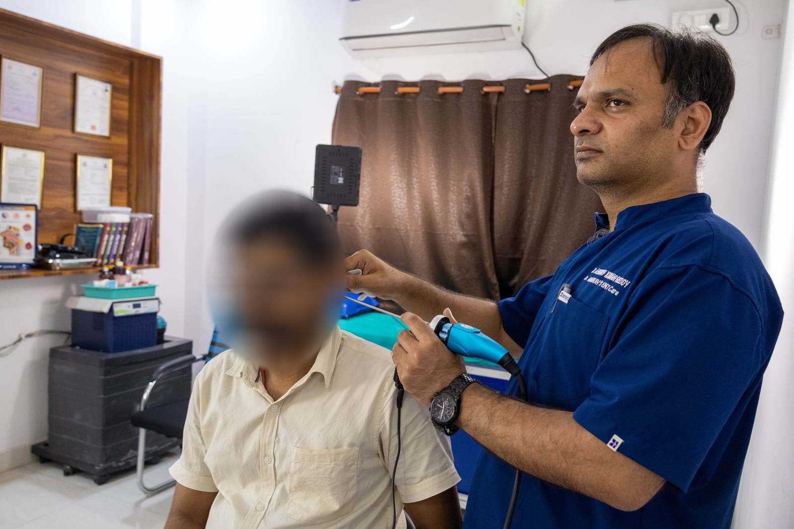 Dr. G Abhinav Kumar Reddy examining a patient with an endoscope